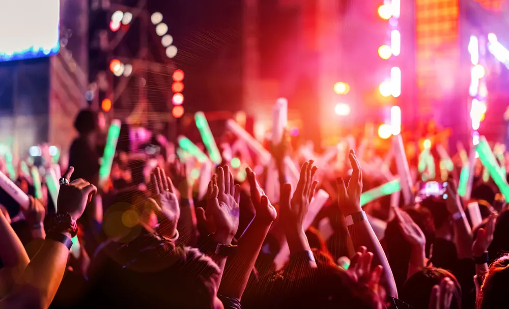 Crowd with raised hands at a live music event