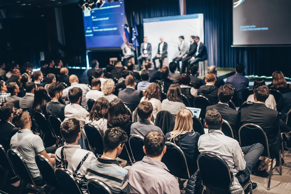 Panel discussion on stage at a corporate conference