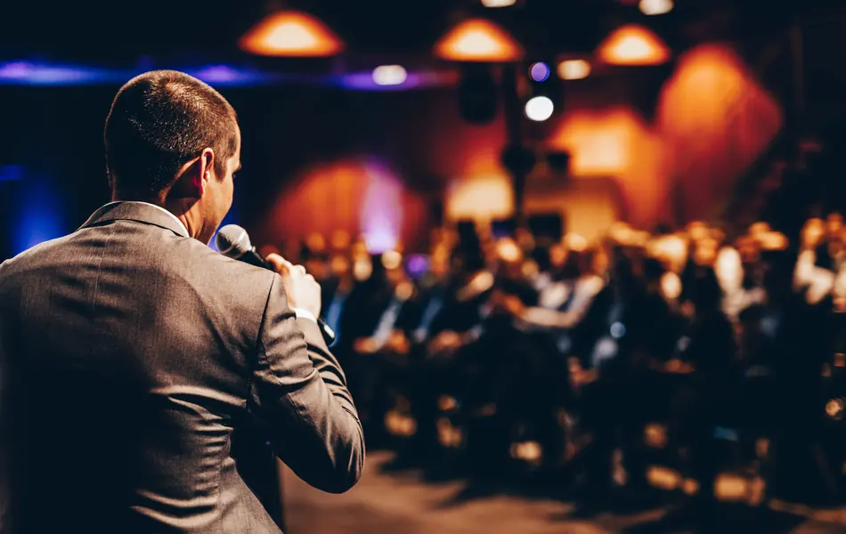 Speaker addressing an audience at a live event