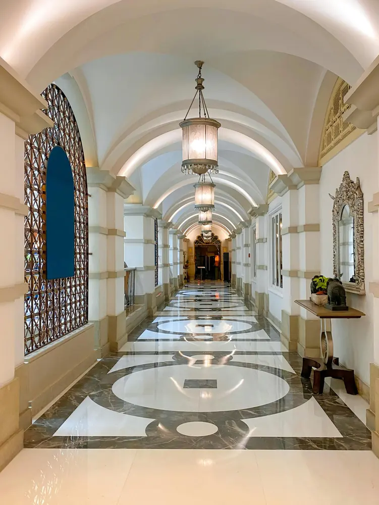 Arched hotel corridor with a marble floor