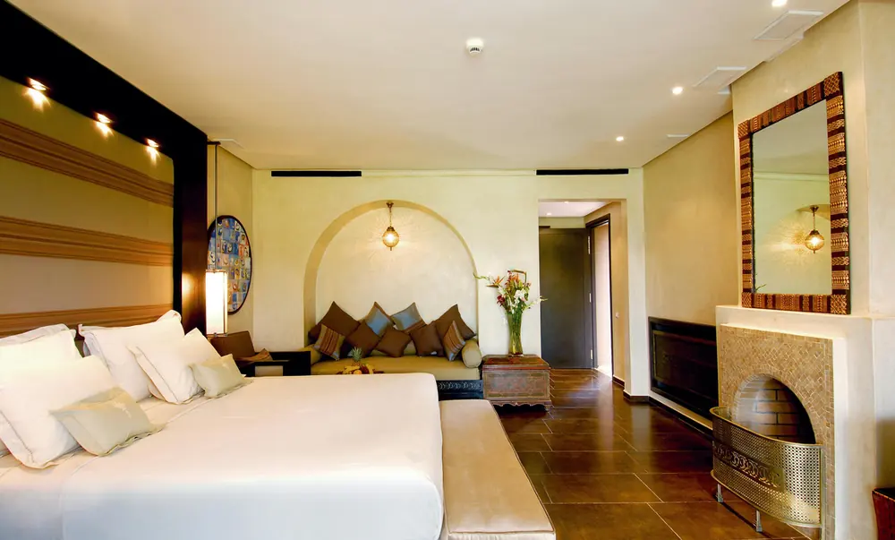 Hotel suite with a large bed and sitting area